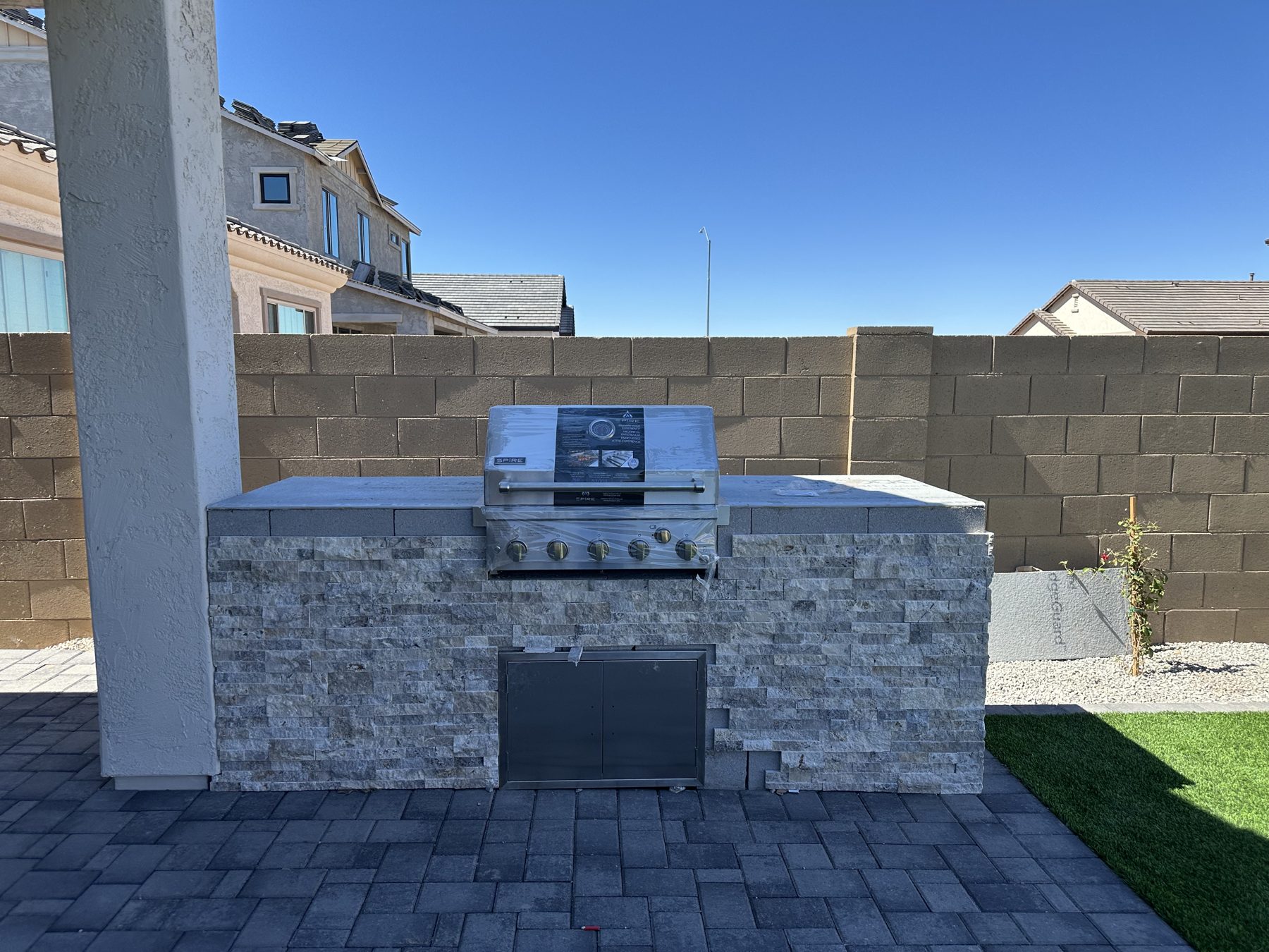 Stacked-stone BBQ island with built-in grill