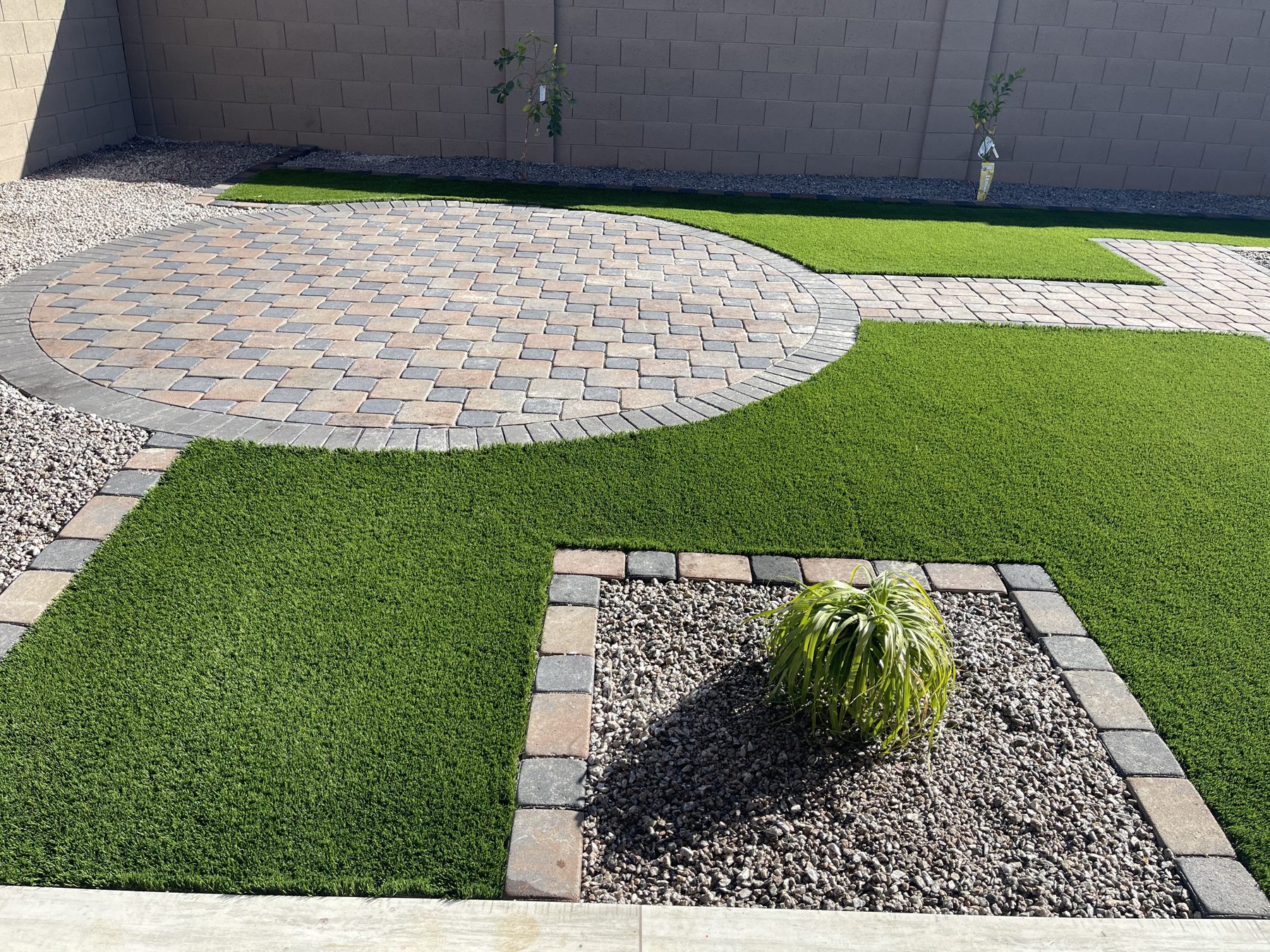 Circular paver patio set into artificial turf