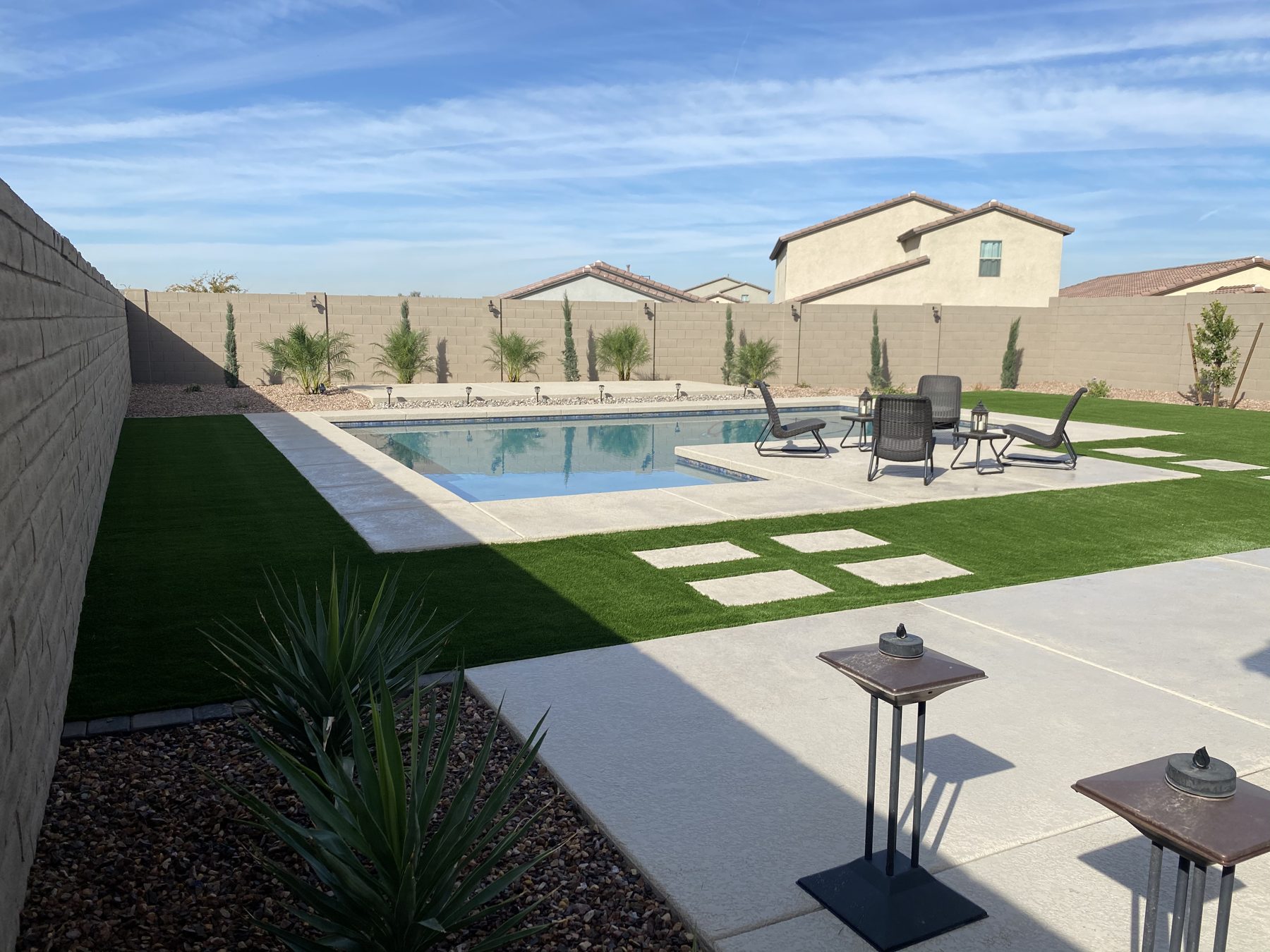 Pool deck with turf, stepping pads and desert planting