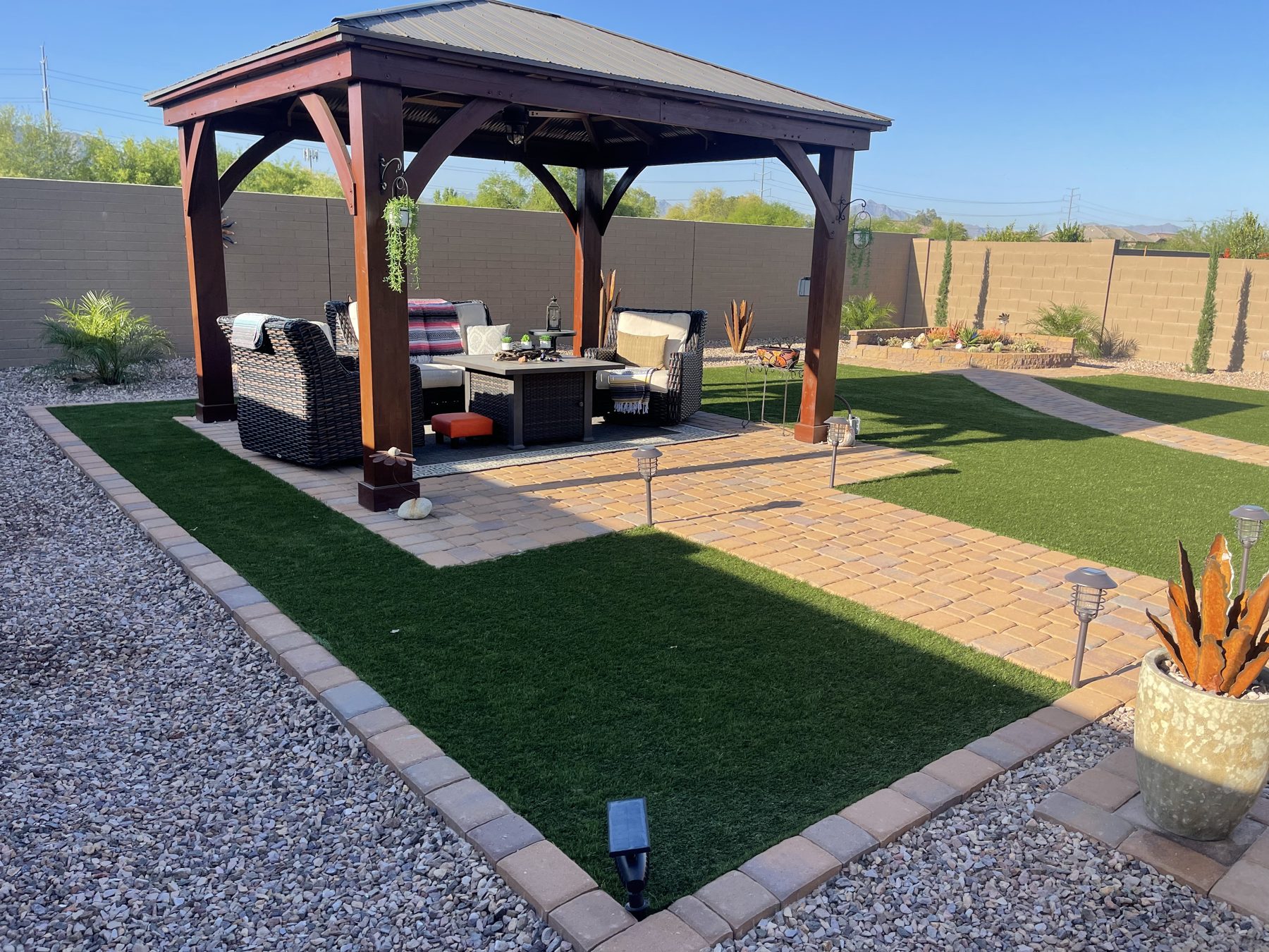 Cedar gazebo with lounge furniture, turf and paver border